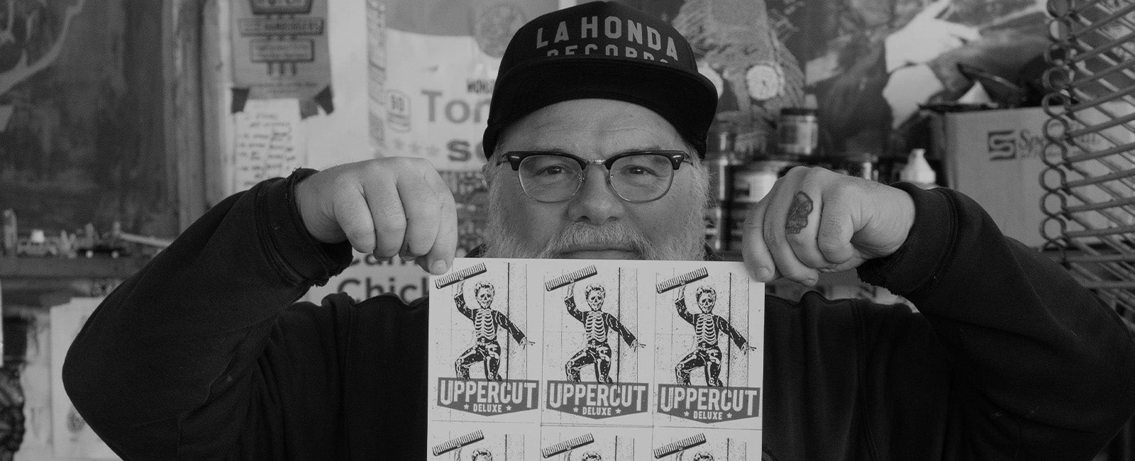 Jim Madison holding up screen printed art for the Skull Dust Campaign