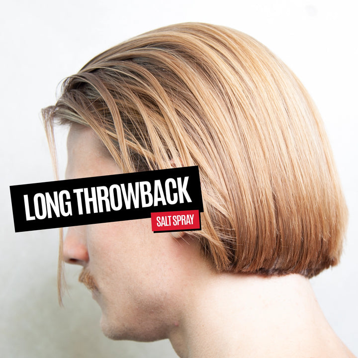 Side profile of a man with a long, straight, salt-baked blonde throwback haircut, with a black text overlay reading 'LONG THROWBACK' and a small red label reading 'SALT SPRAY'.
