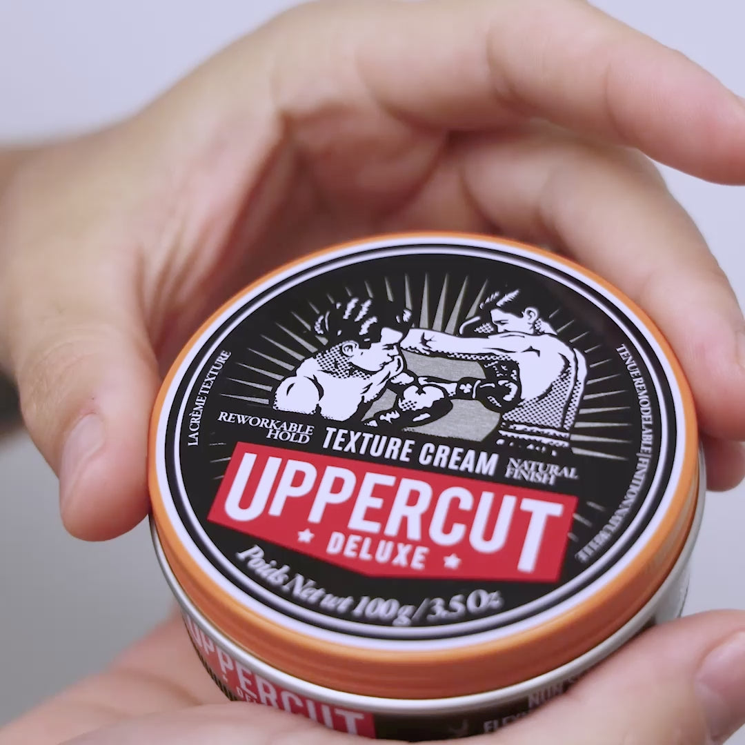 Uppercut Deluxe Texture Cream tin being opened, scooped and spread through hands.